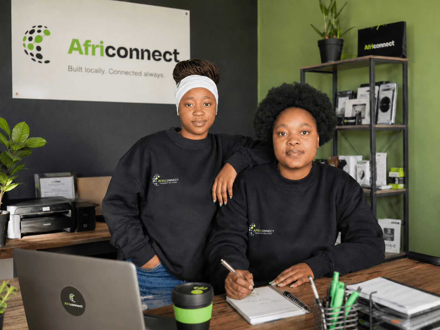 Two AfriConnect team members working together in the Vosloorus office