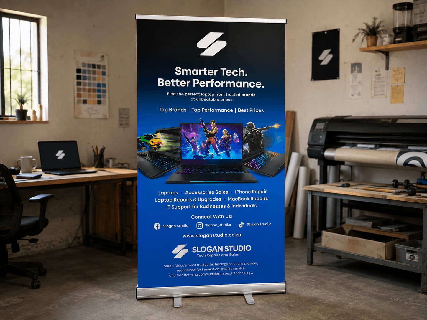 Slogan Studio promotional pull-up banner displayed in a print workshop